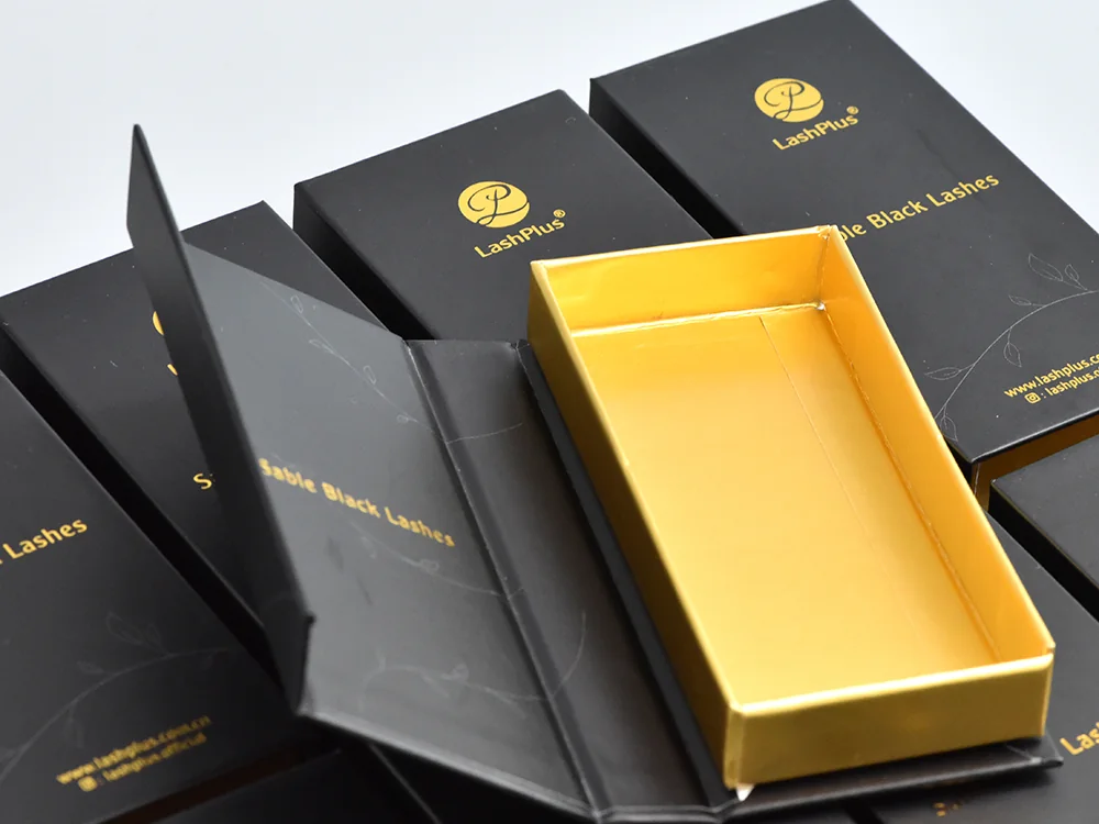 Black private-label lash extension box, open, gold lined