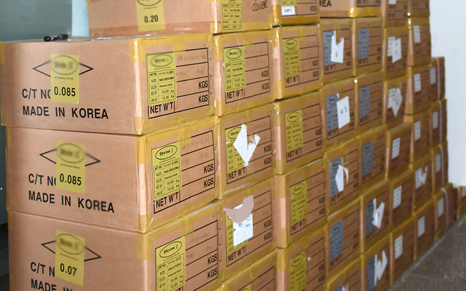 Korean-imported PBT fiber stock at the LashPlus factory