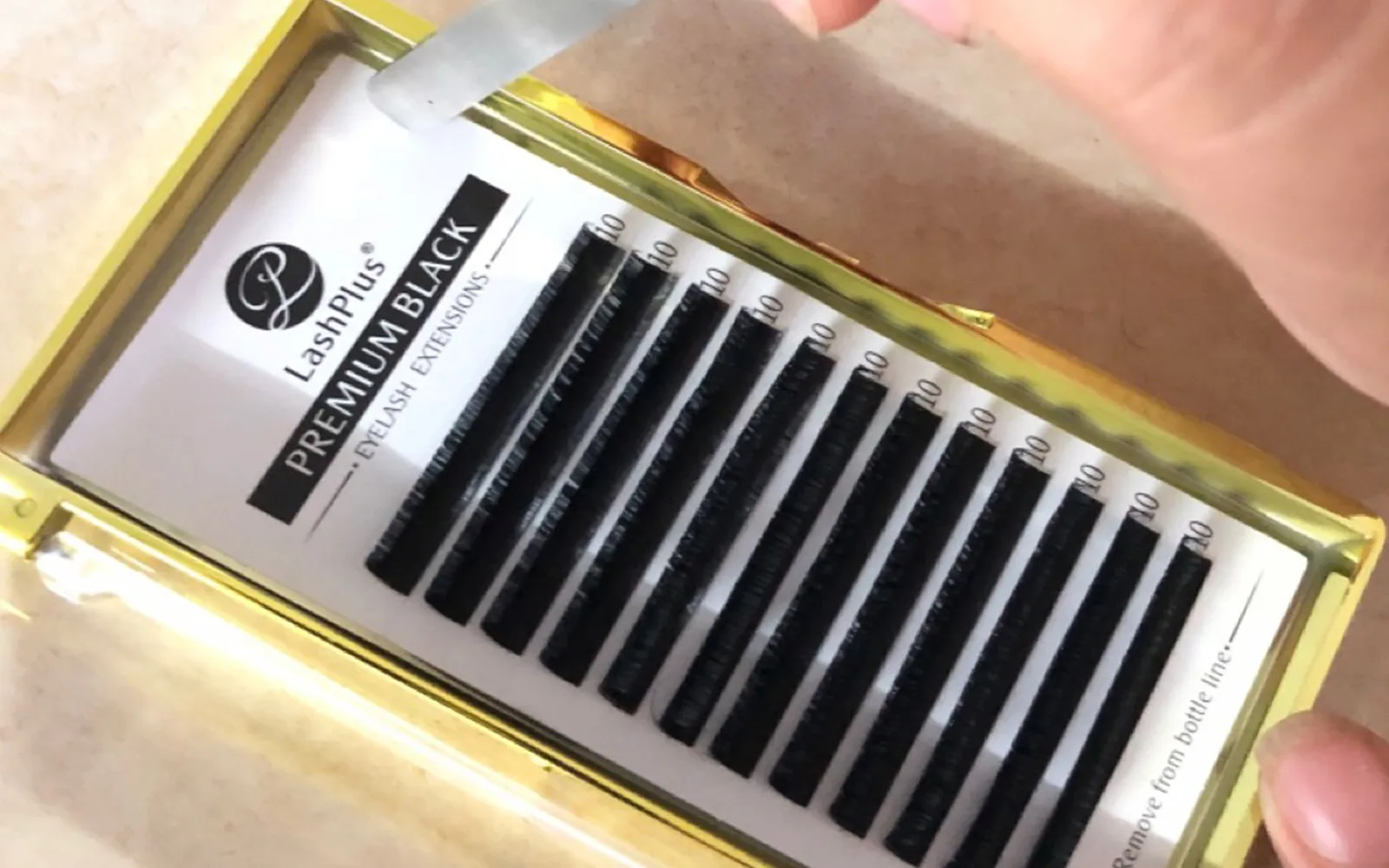 LashPlus quality control — inspecting a lash tray before it ships