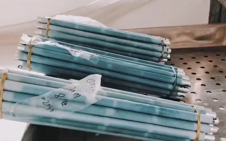 Bundles of curl rods tied and labelled by curl, waiting to be heat-set