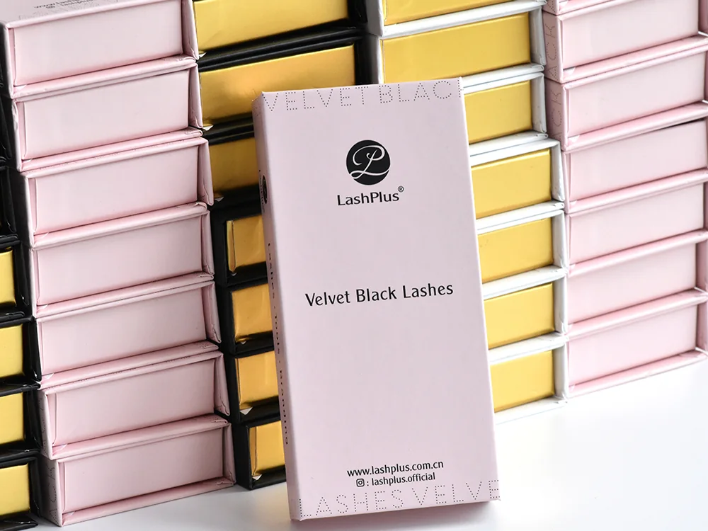 Private-label eyelash extension boxes stacked in pink and gold